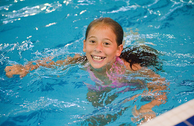 Montclair Soccer Camp presents a kid smiling in the pool.