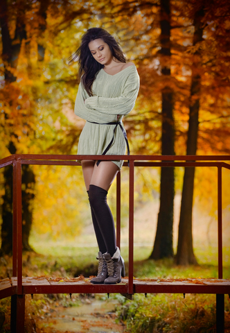 Young Caucasian sensual woman in a romantic autumn scenery. Fall lady .Fashion portrait of a beautiful young woman in forest