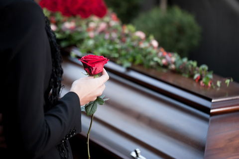 Woman at Funeral with coffin