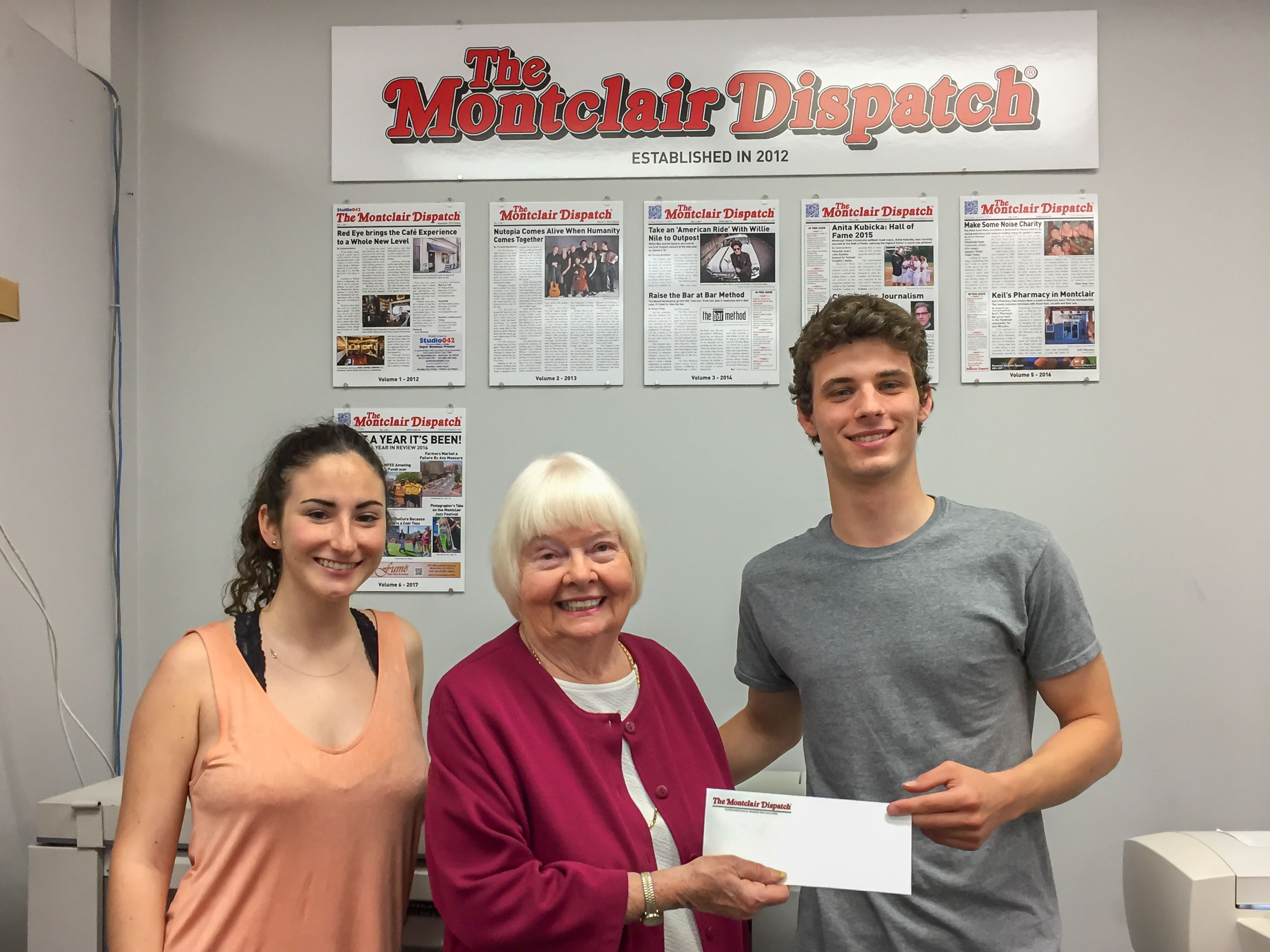 Joe receiving his scholarship check from Catherine Boone, sister of Eleanor Kennedy whom the scholarship is named after. 