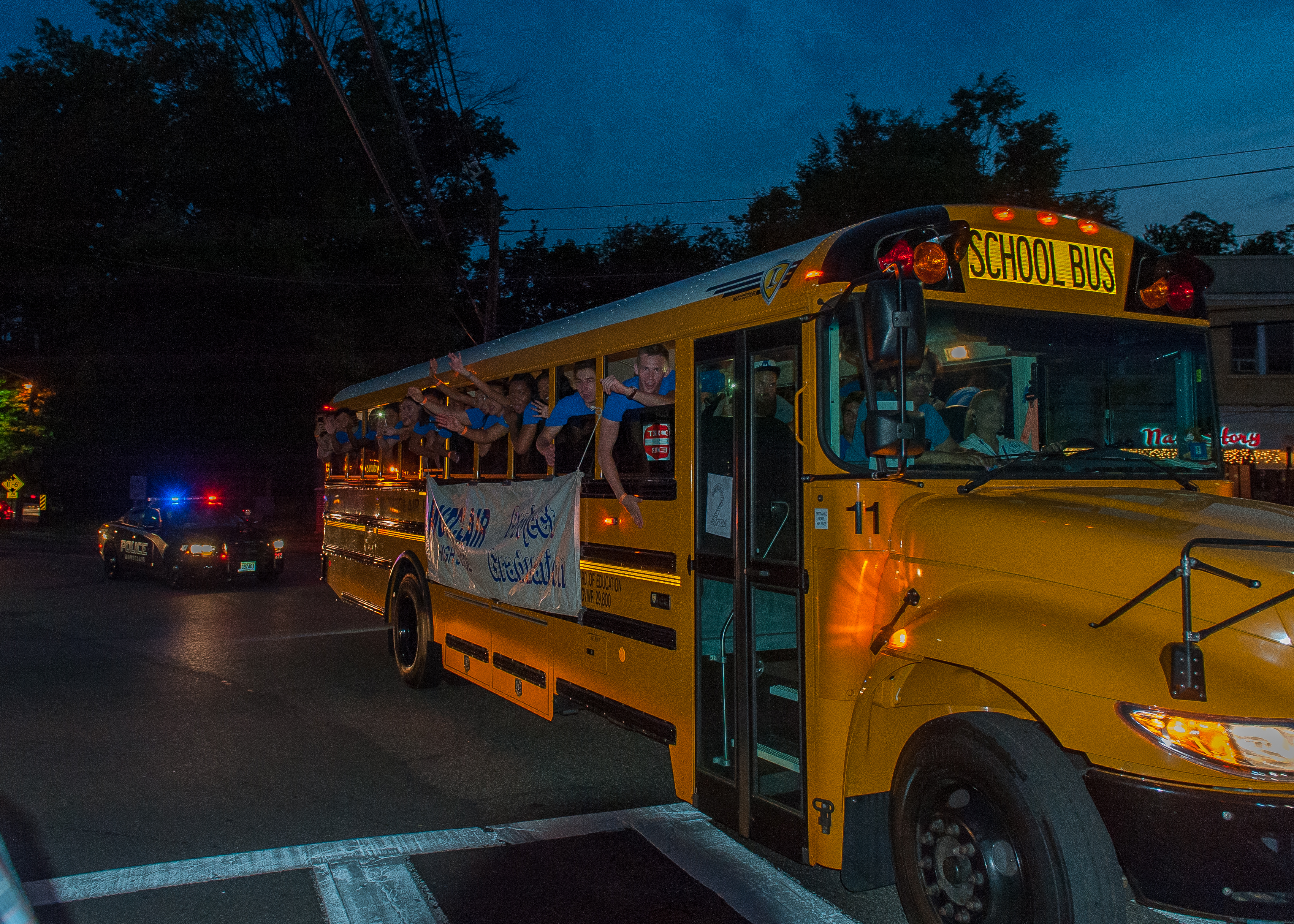 Students riding school busses through Watchung Plaza on their way to Project Graduation. Photo by Scott Kennedy for The Montclair Dispatch.