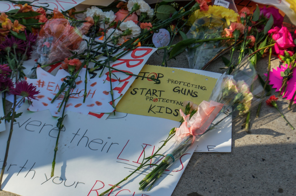 signs and flowers in a show of respect