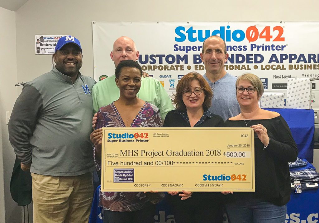 The 2018 MHS Project Graduation committee accepts a donation from Studio042